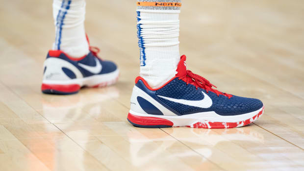 Golden State Warriors guard Gary Payton II's red, white, and blue Nike shoes.